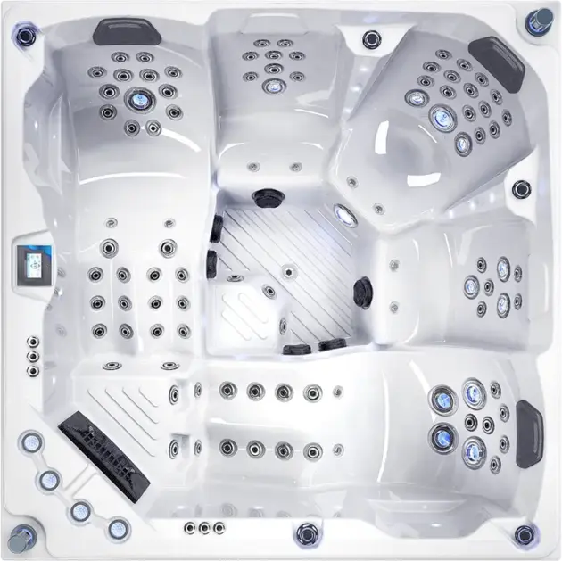 Top-down view of the Harmonia: an empty, modern white hot tub featuring multiple built-in seats, various jets, a digital control panel, cup holders, and textured footrests—perfect for cooling off after sunny Dubai days.