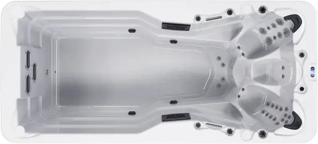 Top-down view of the modern, affordable Aquatica swim spa with a spacious swimming area on the left and multiple contoured seating areas with built-in jets on the right. Its clean, white rectangular design adds luxury—ideal for Dubai lifestyles.